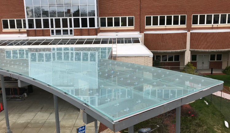 Sno-Safe Clear Polycarbonate Snow Guards on a Glass Canopy